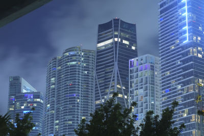 Low angle view of modern buildings against sky in city
