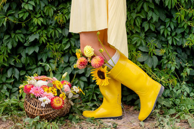 Floral arrangement with rubber boots worn on the feet