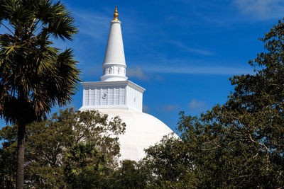 Low angle view of historical building against blue sky