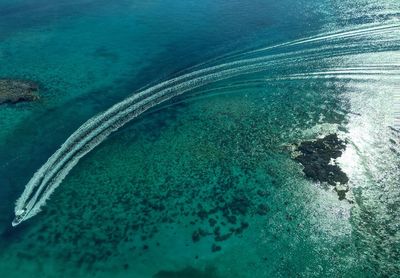 High angle view of sailboat moving on sea