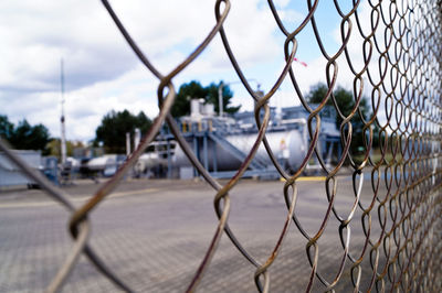 Close-up of chainlink fence against sky