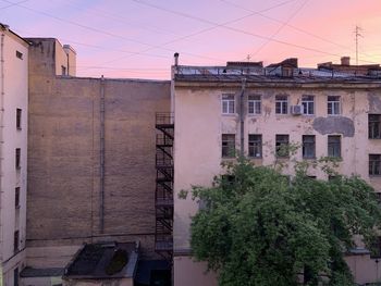 Residential buildings against sky during sunset