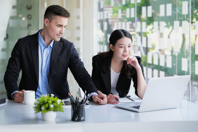 Businesswoman using laptop at table