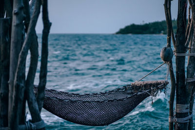 Close-up of rope against sea against clear sky