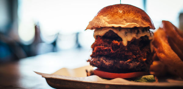 Close-up of burger and onion rings on table