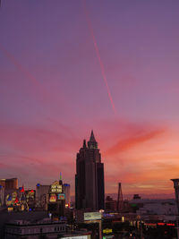 Buildings against cloudy sky during sunset
