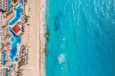 Aerial view of tropical sandy beach with turquoise ocean.