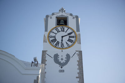 Low angle view of clock tower against clear sky