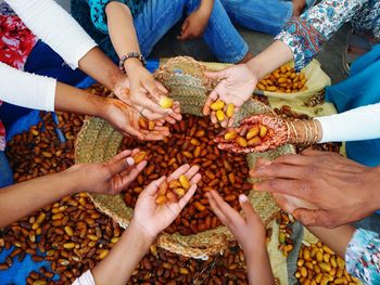 Group of female friends holding food in hands