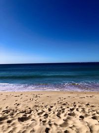 Scenic view of sea against clear blue sky