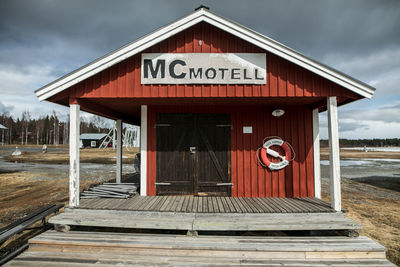 Information sign on built structure against sky