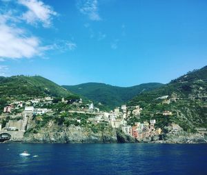 Town by river against clear sky