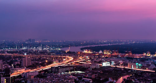 High angle view of illuminated buildings against sky at night