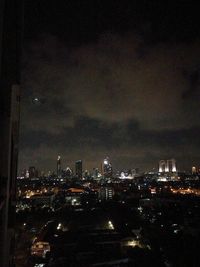 Illuminated cityscape against sky at night