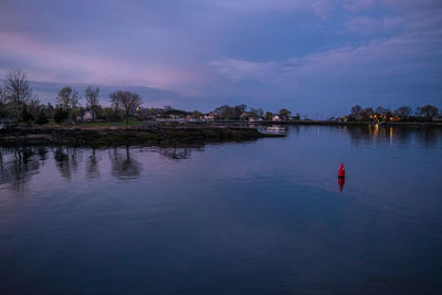 Scenic view of lake against sky at dusk