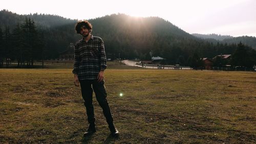 Full length of young man standing on field