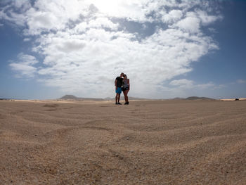 Rear view of man walking on desert