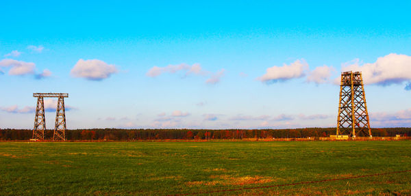 Crane on field against sky