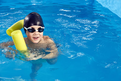 Boy swimming in pool