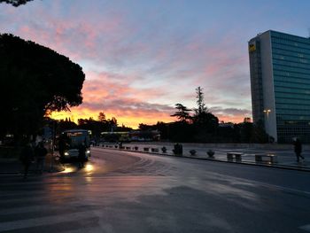 City street against sky during sunset