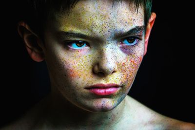 Portrait of young boy with paint on face