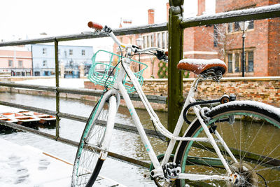 Close-up of bicycle on railing during winter