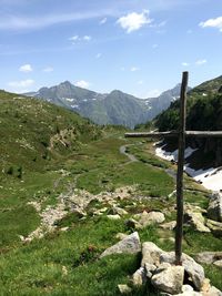 Scenic view of lake by mountains against sky