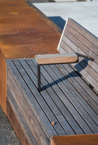 High angle view of wooden chairs on pier