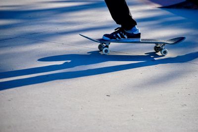 Low section of man skateboarding on snow