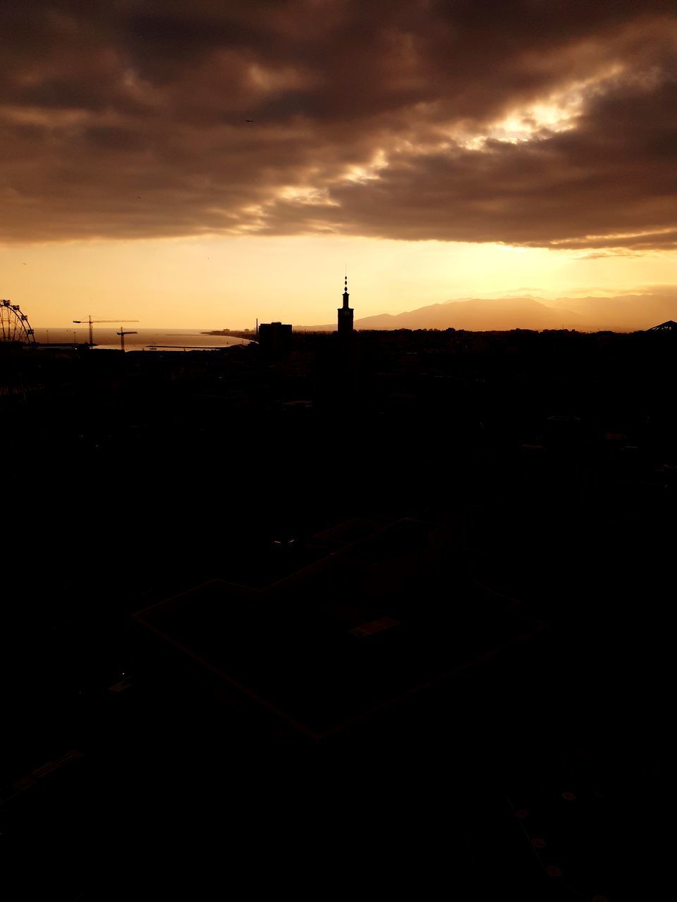 SILHOUETTE BUILDINGS AGAINST SKY DURING SUNSET