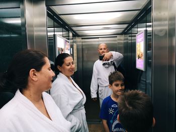 Portrait of friends standing in corridor