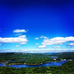 Scenic view of agricultural field against blue sky