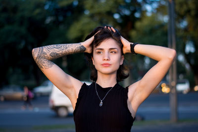 Portrait of young woman standing outdoors