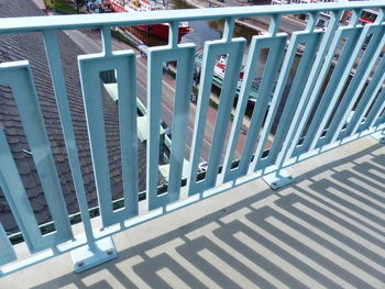 High angle view of railing by fence