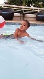 High angle view of enjoying in swimming pool