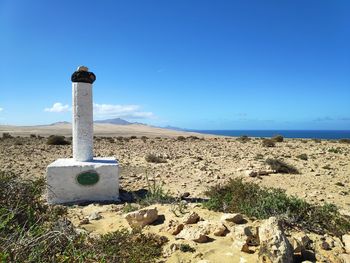 Scenic view of land against clear blue sky