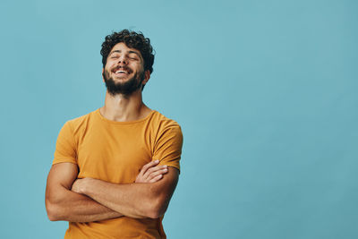 Low angle view of young man standing against clear sky