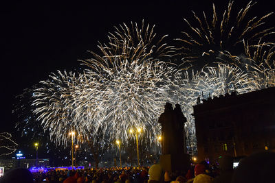 Low angle view of firework display at night