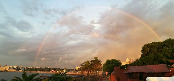 Scenic view of rainbow over city buildings