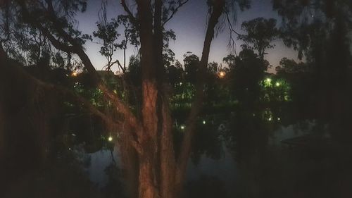 Scenic view of lake against sky at night