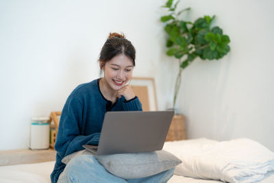 Young woman using laptop at home