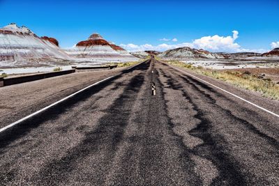 Panoramic view of road leading towards mountains against sky