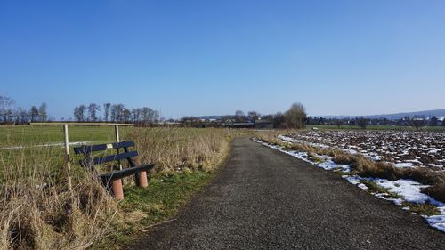 Agricultural field against clear blue sky