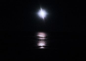 Scenic view of sea against sky at night