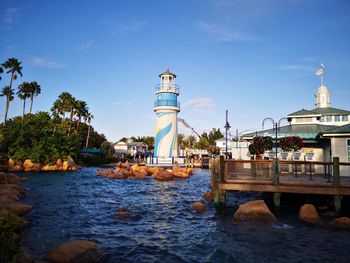 View of lighthouse by sea against sky