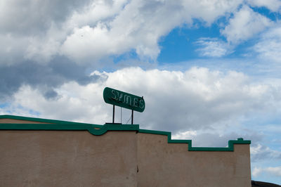 Low angle view of road sign against sky