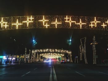 Illuminated city against sky at night