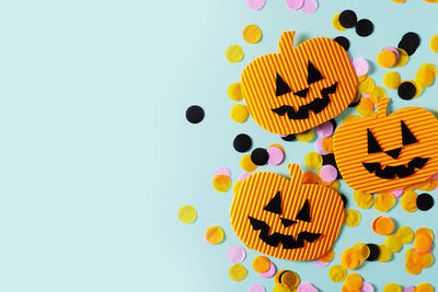 High angle view of multi colored paper over white background