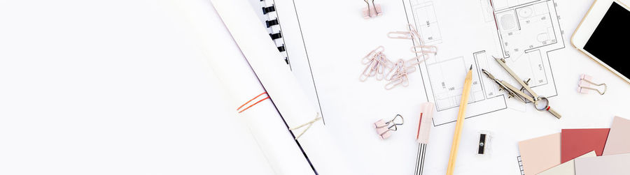 Close-up of multi colored paper hanging over white background