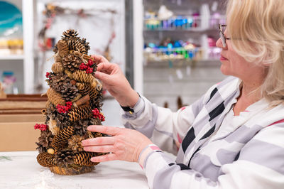 Woman arranging pine cone